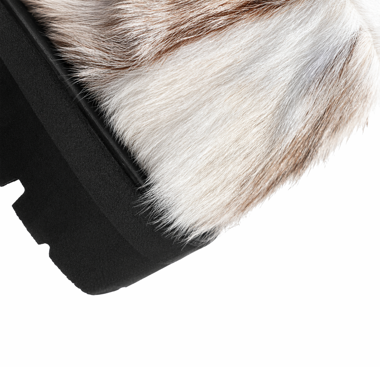 MOGSki boot detail showing natural fur upper and anti-slip rubber sole contrast, luxury handcrafted winter footwear