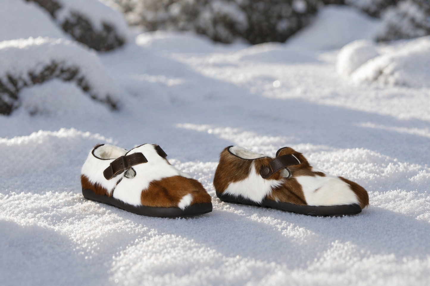 MOGSki handcrafted fur slippers in snowy winter landscape, natural sheepskin luxury footwear, made by Mongolian artisans