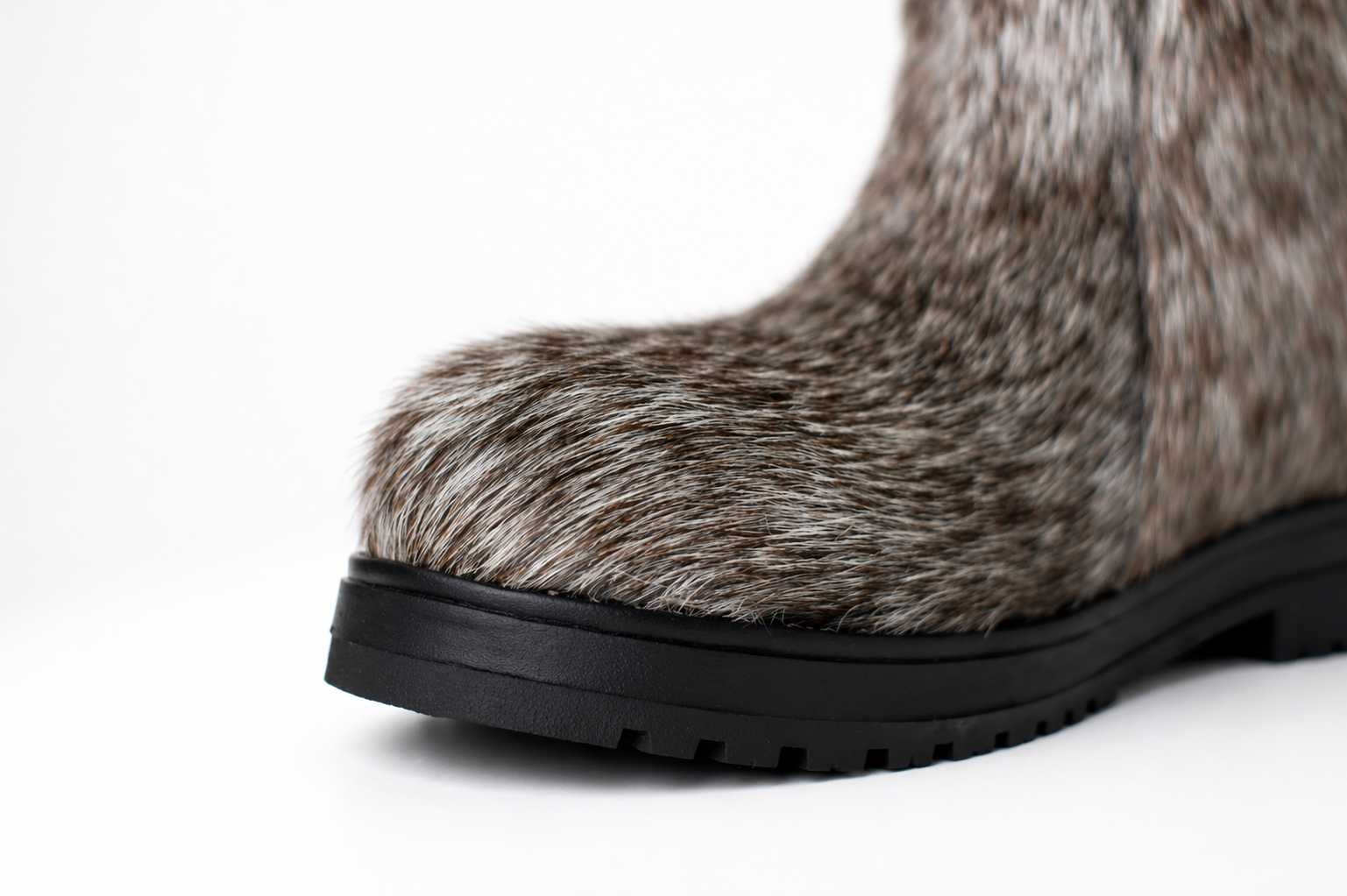 MOGSki natural fur boot close up showing genuine hide texture and durable black outsole, luxury handcrafted winter footwear