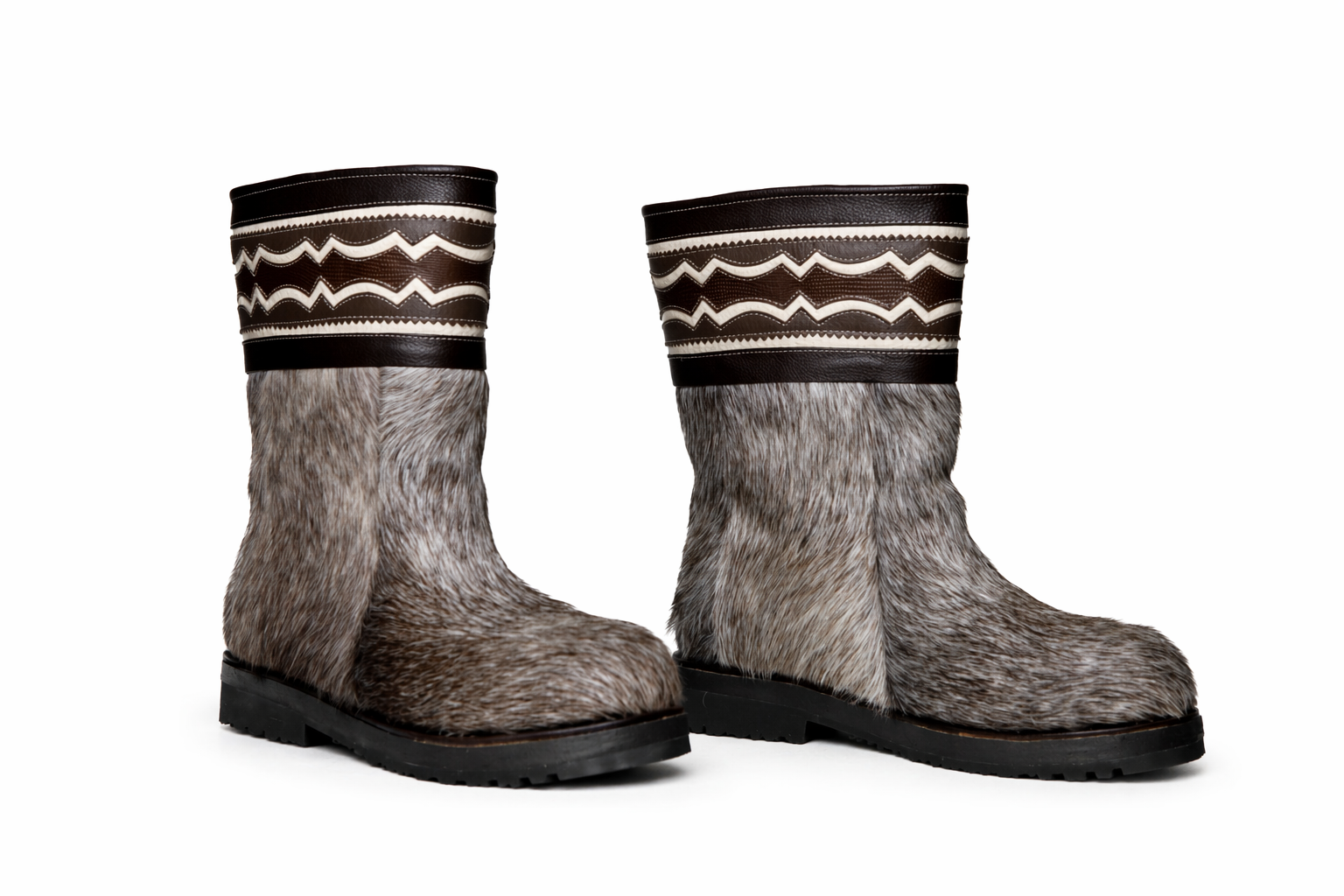 MOGSki handcrafted fur winter boots on clean white background, natural hide luxury footwear product photography Mongolia