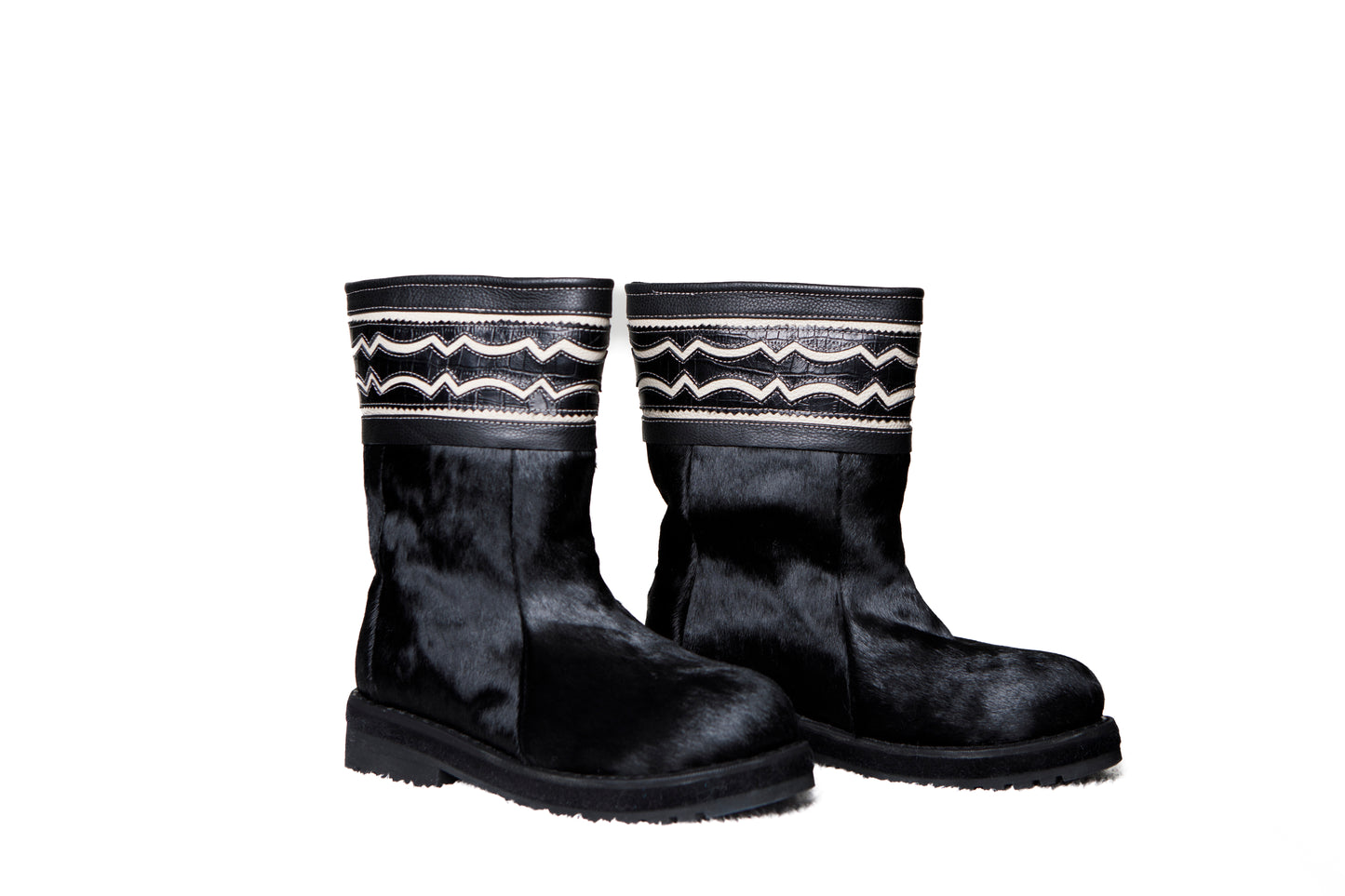 MOGSki handcrafted black cowhide tall boots product photography, luxury natural hide winter footwear from Inner Mongolia