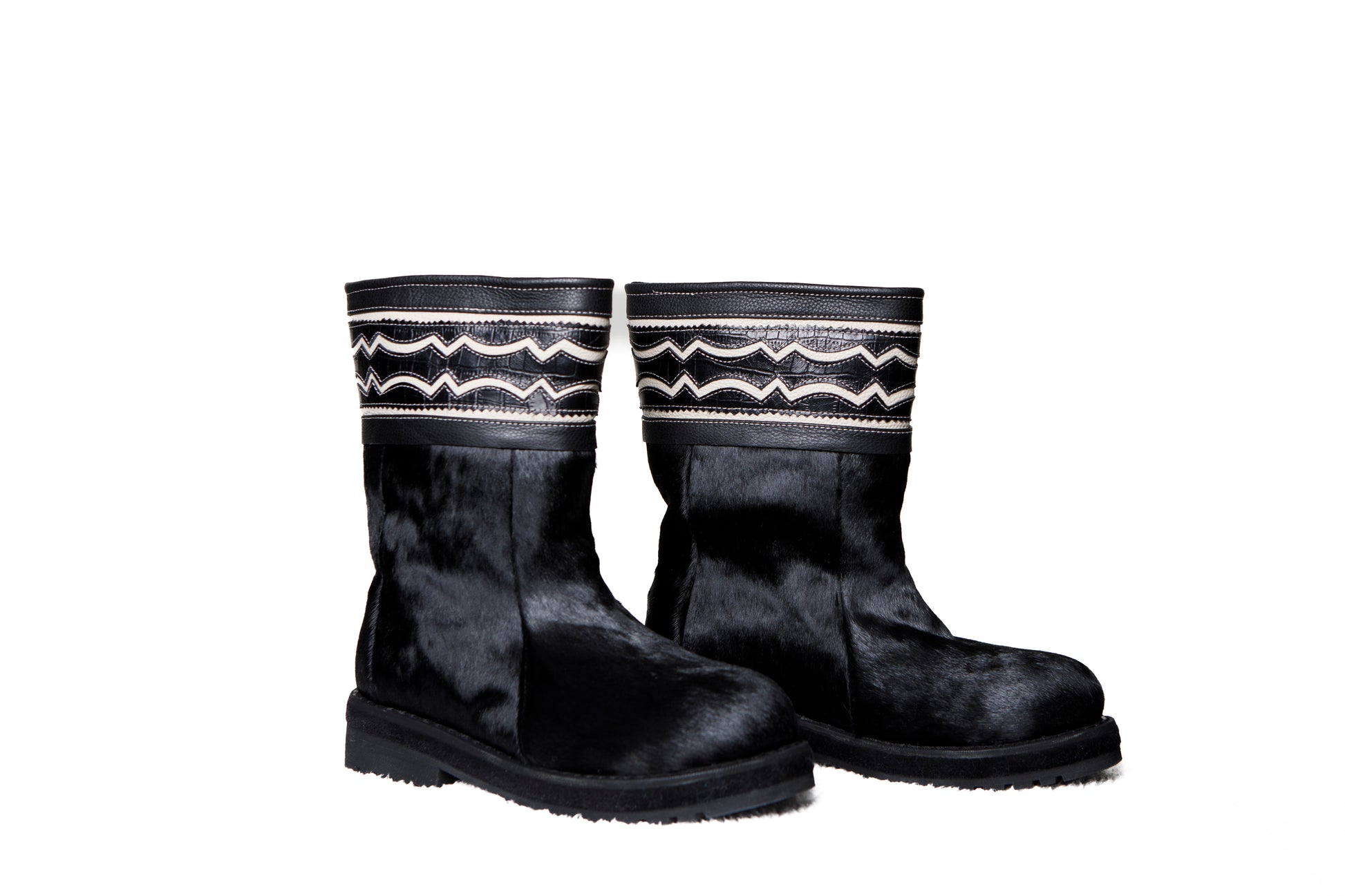 MOGSki handcrafted black cowhide tall boots product photography, luxury natural hide winter footwear from Inner Mongolia
