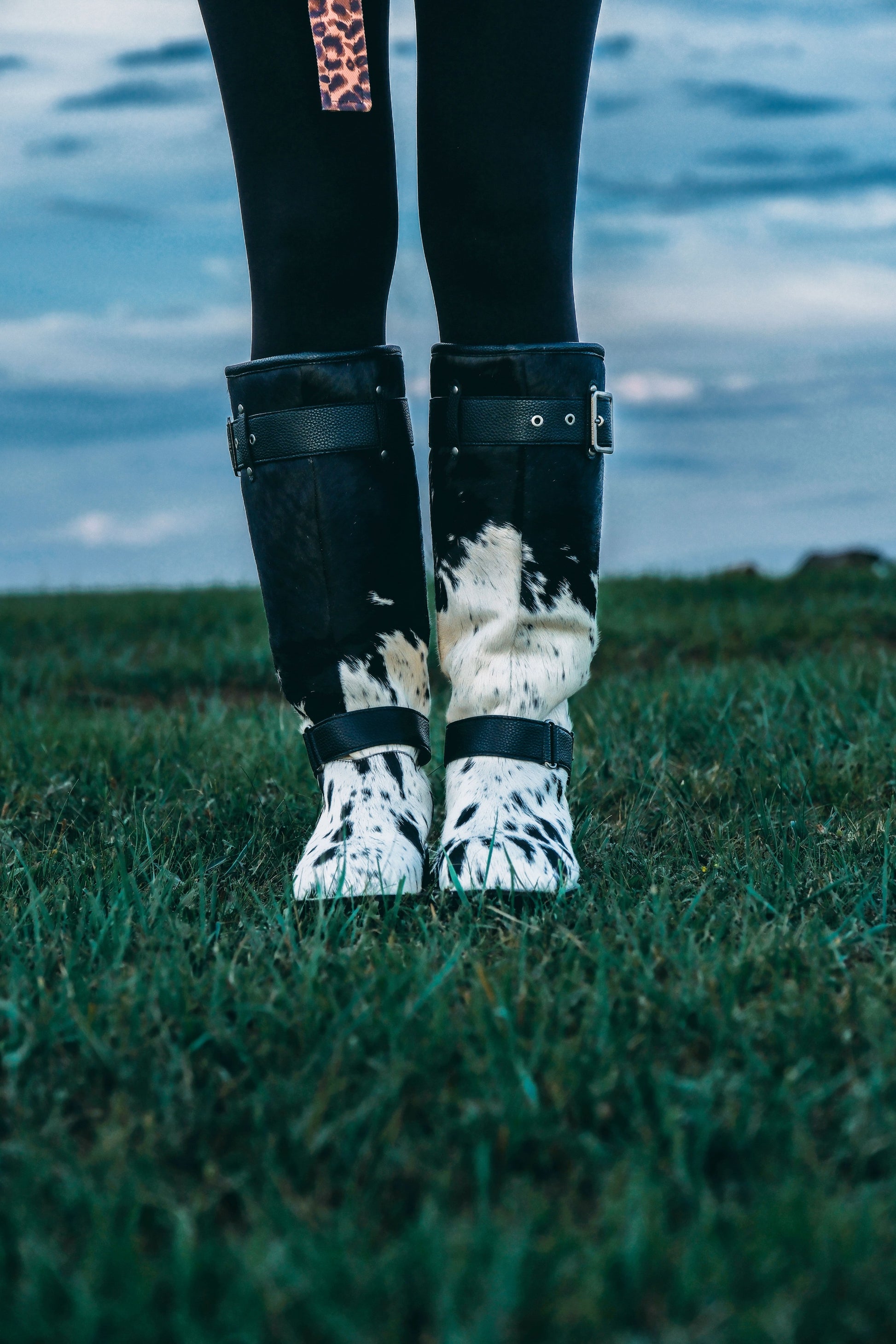 MOGSki natural cowhide boots detail worn outdoors, luxury handcrafted Mongolian winter footwear on grass lifestyle shot