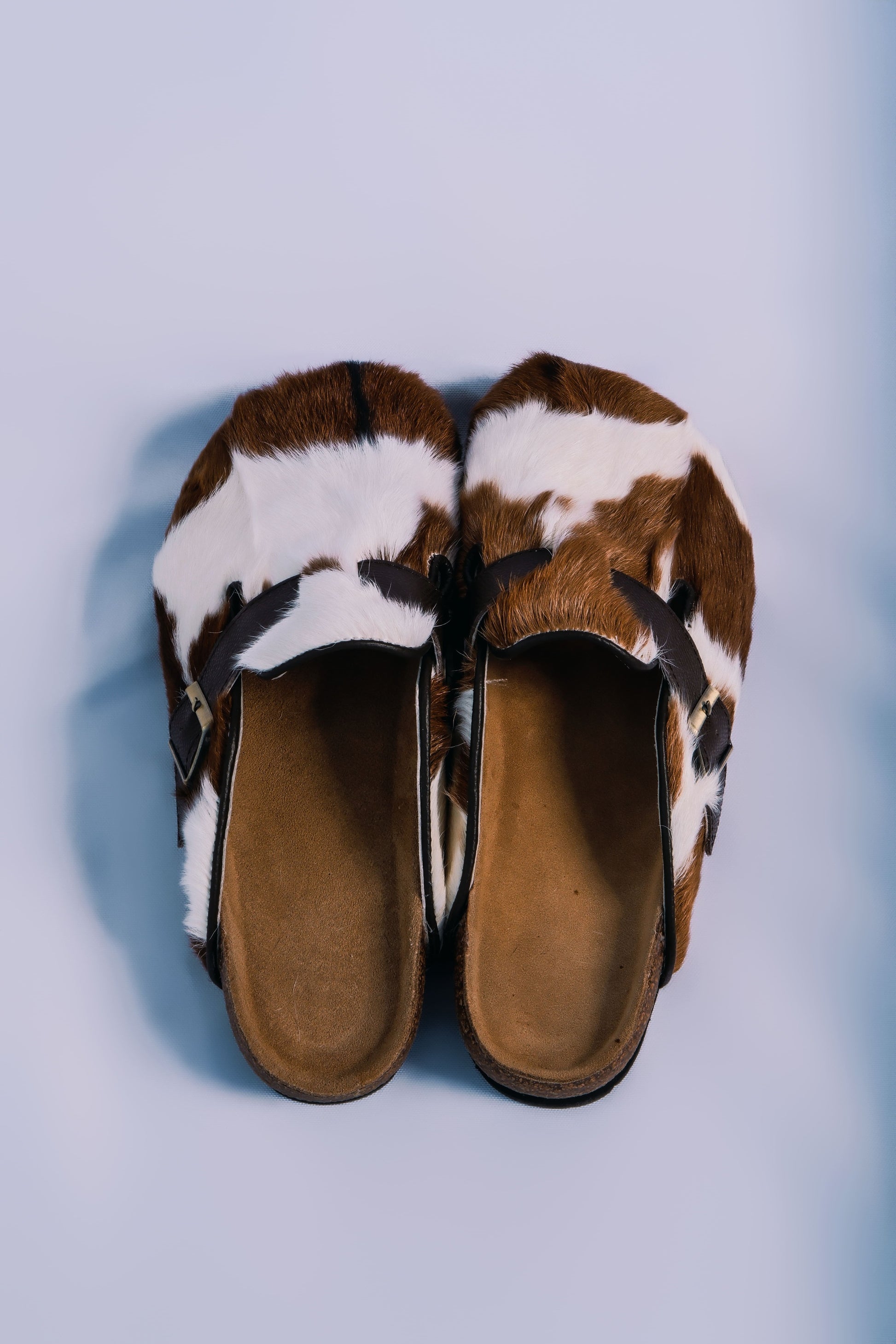 MOGSki handcrafted natural cowhide fur clogs pair top view product shot, luxury genuine hide footwear from Inner Mongolia