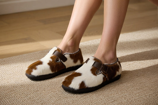 Woman wearing MOGSki natural cowhide Mary Jane flats on marble floor, luxury handcrafted Mongolian footwear lifestyle