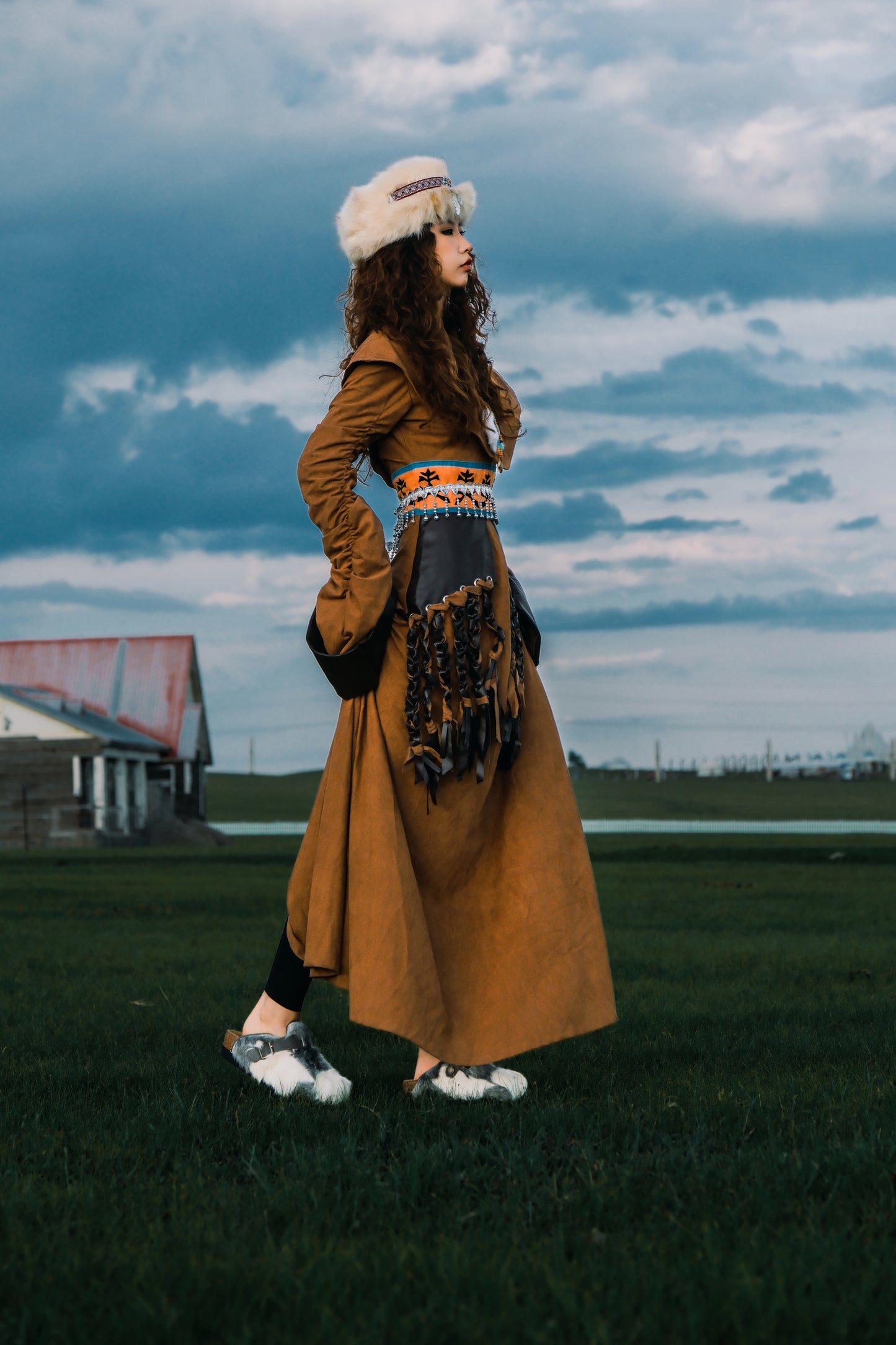 MOGSki natural fur boots with golden dress outdoor editorial, luxury handcrafted Mongolian footwear lifestyle shot