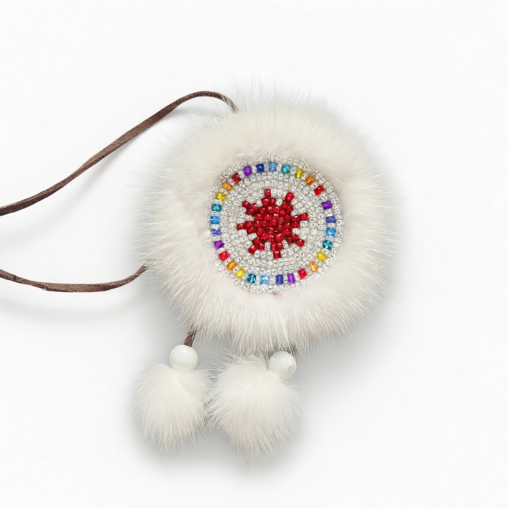 MOGSki handcrafted mink fur disc brooch with red and white beaded Mongolian sunburst motif, luxury artisan jewelry