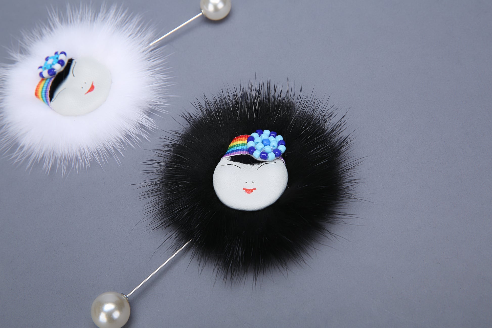 MOGSki mink fur pompom pin close up, natural white and black fur, luxury handcrafted jewelry from Inner Mongolia